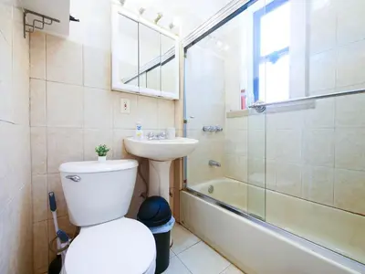 a bathroom with a toilet and a sink and a shower at Charming 1BR Apartment Near NYC Ideal for Urban Explorers in Jersey City