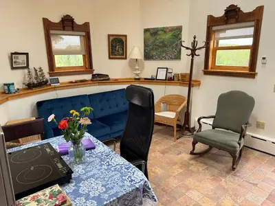 a living room with a blue couch and chairs at Idea Farm in Callicoon Center