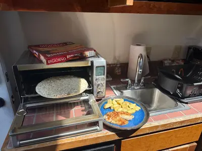 a kitchen counter with a toaster oven and a plate of food at Idea Farm in Callicoon Center