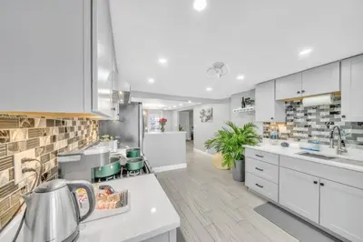 a kitchen with white cabinets and a counter top at 3 Bedroom Duplex w Large Backyard in Brooklyn