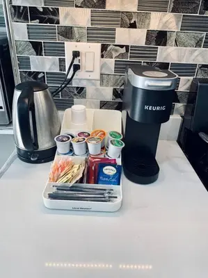 a coffee maker and a container with food and cups on a counter at 3 Bedroom Duplex w Large Backyard in Brooklyn