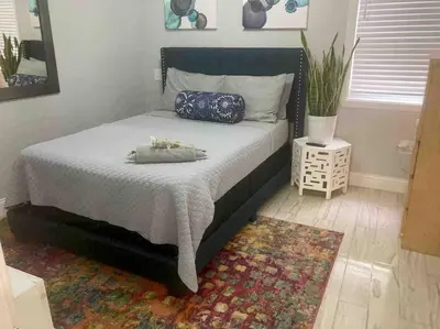 a bedroom with a large bed with a rug at 3 Bedroom Duplex w Large Backyard in Brooklyn