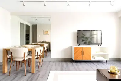 a dining room with a table and a tv on a wall at Downtown Hartford Condo - Ciy Center - Prime Location in Hartford
