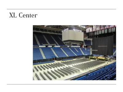 an empty stadium with blue seats in it at Downtown Hartford Condo - Ciy Center - Prime Location in Hartford