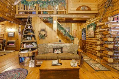 a living room with a couch in a log cabin at Lake and Beach Access at Lake Luzerne Cabin! in Lake Luzerne