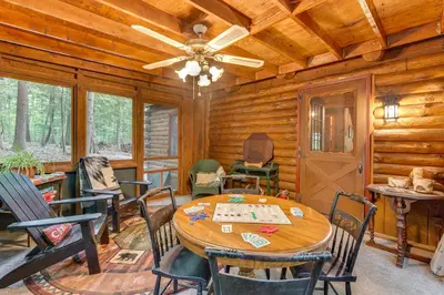 a dining room with a table and chairs in a cabin at Lake and Beach Access at Lake Luzerne Cabin! in Lake Luzerne