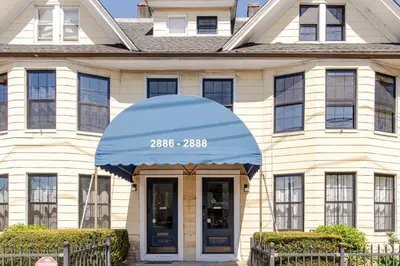 a house with a blue awning in front of it at Black Rock Suites-86-1 in Bridgeport