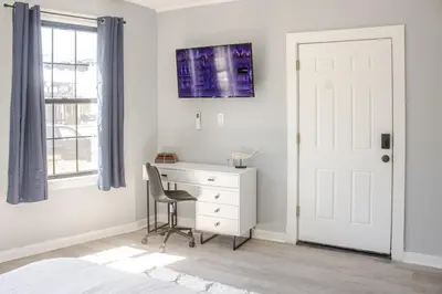a bedroom with a desk and a chair next to a window at Black Rock Suites-86-1 in Bridgeport