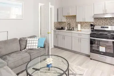 a living room with a couch and a glass table at Black Rock Suites-86-1 in Bridgeport
