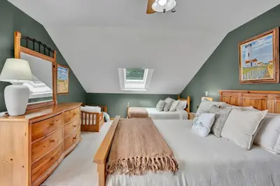 a bedroom with two beds and a television in it at Lakefront Family Home, Kayaks, Hot Tub, Fireplace in Lake Ariel