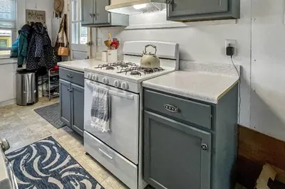 a kitchen with a stove and a tea kettle on it at Beachside in Branford in Stamford