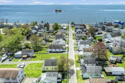 an aerial view of a small town with houses and the ocean at Beachside in Branford in Stamford