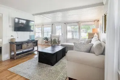 a living room with a couch and a flat screen tv at Beachside in Branford in Stamford