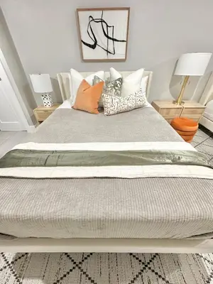 a large bed with pillows on it in a bedroom at Dream Home Close to the Center of NYC in Mott Haven