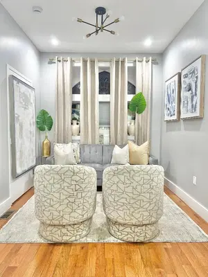 a living room with two chairs and a couch at Dream Home Close to the Center of NYC in Mott Haven