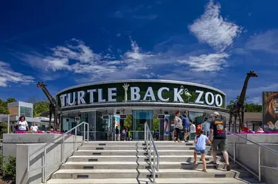 a group of people standing in front of a turtle back zoo at Family & Traveler Haven - NYC & NWK w/free parking in Newark