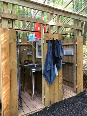 a wooden pergola with a sink and a stove at Red Creek Hideaway in Cooperstown NY in Cooperstown