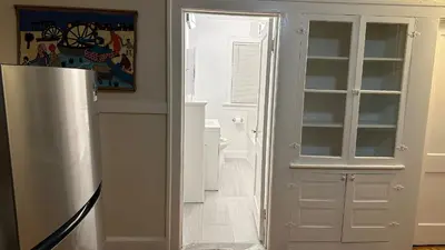a kitchen with a refrigerator and a door to a room at Cozy Albany Home in Albany