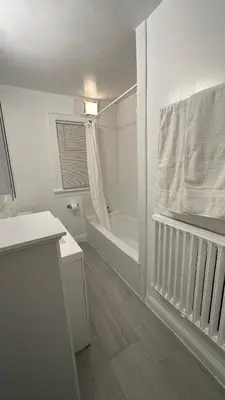 a white bathroom with a tub and a shower at Cozy Albany Home in Albany