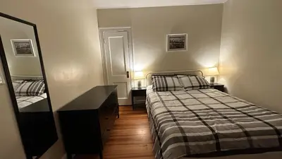 a bedroom with a bed and a dresser and a mirror at Cozy Albany Home in Albany