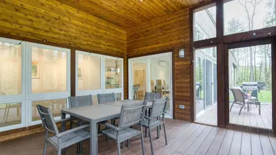 a dining room with a table and chairs at Secluded Modern Enclosed Patio Forest Views Woodland Zen by AvantStay in Stockbridge