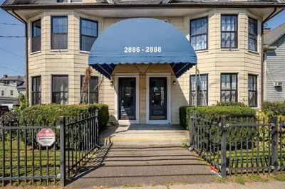 a house with a blue awning in front of it at Modern Apartment in Black Rock- in Bridgeport