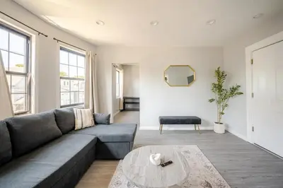 a living room with a couch and a table at Modern 3-Bdrm Apt in Black Rock in Bridgeport