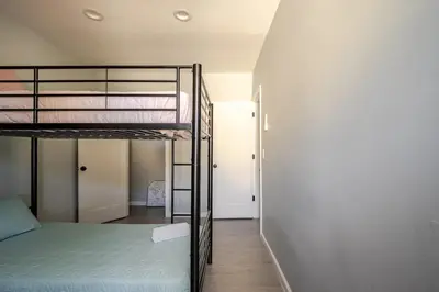 a bedroom with two bunk beds and a hallway at Modern 3-Bdrm Apt in Black Rock in Bridgeport