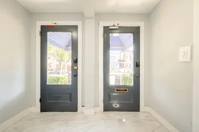 two blue doors in a white room withermottermottermottermottermott at Modern 3-Bdrm Apt in Black Rock in Bridgeport