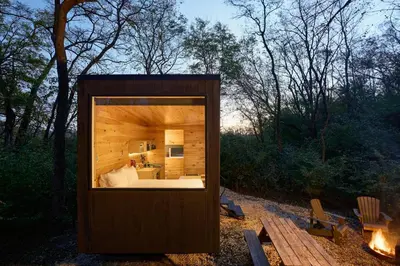 a small cabin with a large window in the woods at Postcard Cabins Machimoodus, Outdoor Collection by Marriott Bonvoy in Moodus