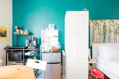 a room with a bed and a blue wall at Not operating in Jackson Heights
