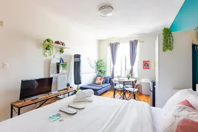 a bedroom with a bed and a living room at Not operating in Jackson Heights