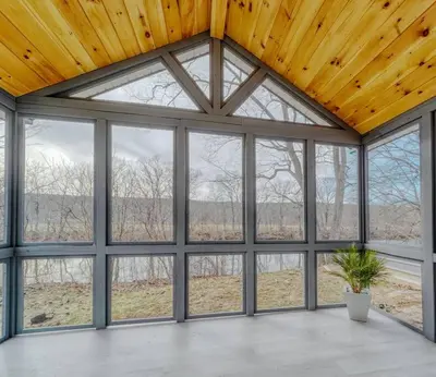 an empty room with large windows and a ceiling at Brand New House with Large Porch in Lake Katrine in Lake Katrine