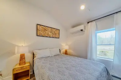a bedroom with a bed and a window at Brand New House with Large Porch in Lake Katrine in Lake Katrine