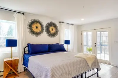 a bedroom with a bed and two mirrors on the wall at Brand New House with Large Porch in Lake Katrine in Lake Katrine