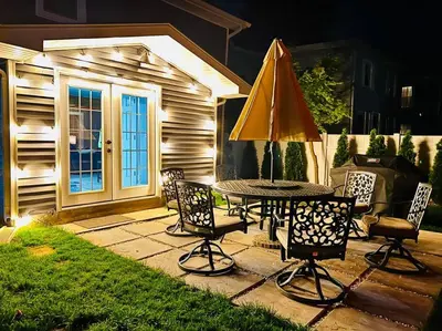 a patio with a table and an umbrella at New 3b House in Saugerties Village 4 mins to HITs in Saugerties