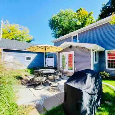 a patio with a table and chairs and an umbrella at New 3b House in Saugerties Village 4 mins to HITs in Saugerties
