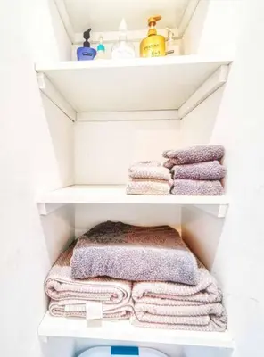 a bathroom with white shelves with towels on them at New 3b House in Saugerties Village 4 mins to HITs in Saugerties