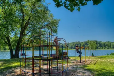 two men are playing on a playground by the water at New 3b House in Saugerties Village 4 mins to HITs in Saugerties