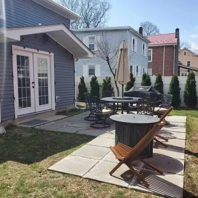 a patio with a table and chairs and an umbrella at New 3b House in Saugerties Village 4 mins to HITs in Saugerties