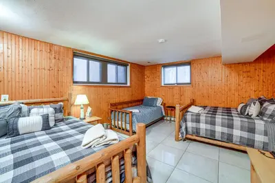 a bedroom with two beds and a couch and a chair at Massive Roscoe Retreat Great for Large Groups! in Roscoe