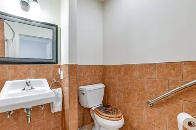 a bathroom with a toilet and a sink at Massive Roscoe Retreat Great for Large Groups! in Roscoe