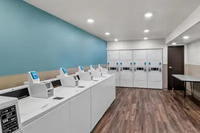 a laboratory with a row of machines in a room at WoodSpring Suites Newington - Hartford South in Newington