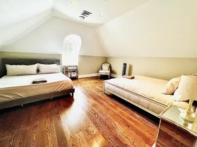 two beds in a room with wooden floors at Chateau Montreau on Hudson in Newburgh