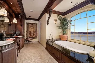 a bathroom with a large tub and a large window at Chateau Montreau on Hudson in Newburgh