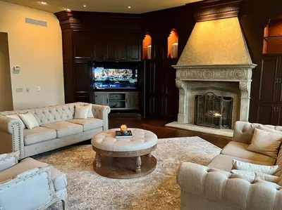 a living room with couches and a fireplace with a tv at Chateau Montreau on Hudson in Newburgh