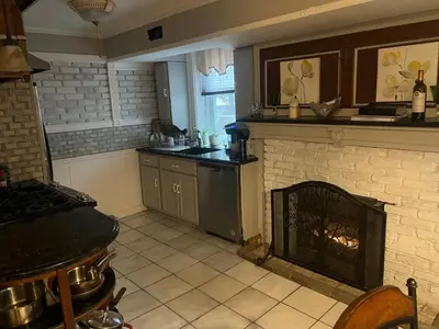 a kitchen with a stove and a fire place at 2 Br Victorian Apt 2800 sq ft 2 floors with Full Kitchen 2 baths and Laundry in Poughkeepsie
