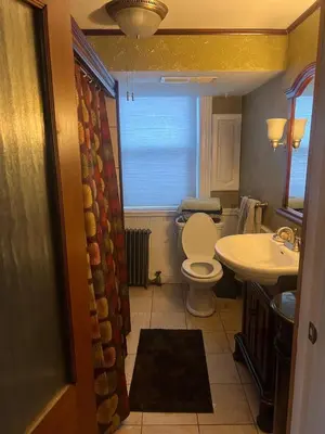 a bathroom with a toilet and a sink at 2 Br Victorian Apt 2800 sq ft 2 floors with Full Kitchen 2 baths and Laundry in Poughkeepsie