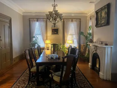 a dining room with a table and chairs and a fireplace at 2 Br Victorian Apt 2800 sq ft 2 floors with Full Kitchen 2 baths and Laundry in Poughkeepsie