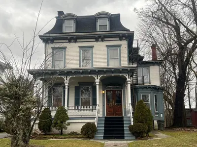 a large white house with a gambrel roof at 2 Br Victorian Apt 2800 sq ft 2 floors with Full Kitchen 2 baths and Laundry in Poughkeepsie